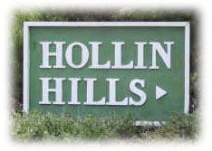Hollin Hills community wooden entrance sign painted in green with white lettering located at Paul Spring Rd